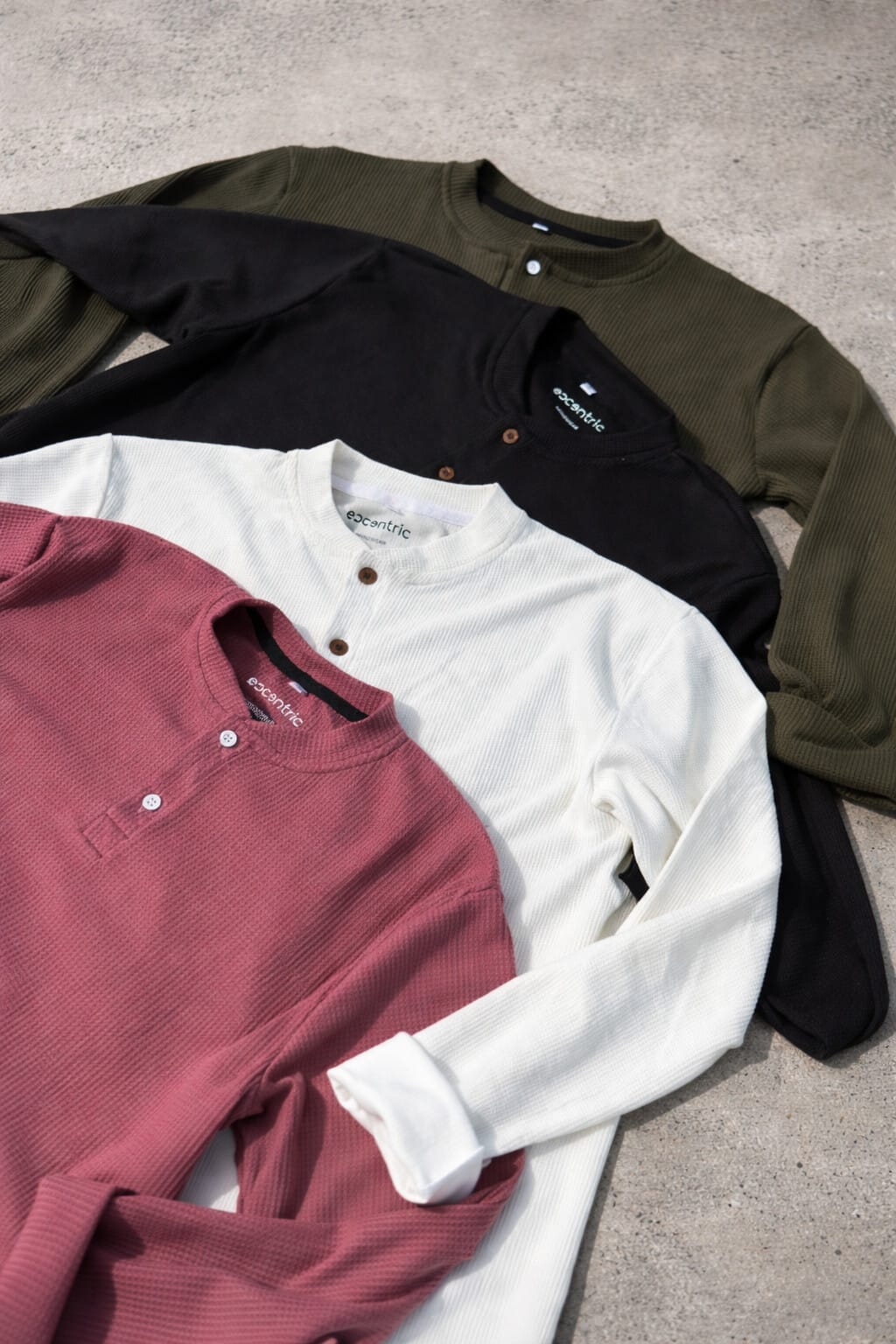 Waffle-knit Henley shirts on concrete